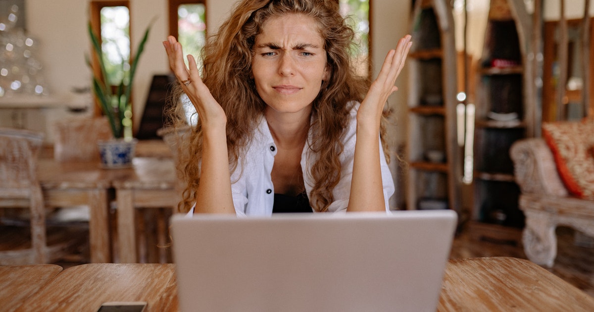 woman frowning at a laptop